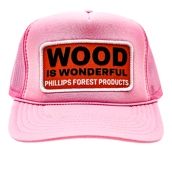 A light pink trucker hat with a Wood is Wonderful Phillips Forest Products patch