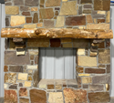 Solid live edge ash fireplace mantel mounted on a stone wall.