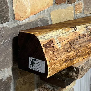 Solid live edge bois d arc fireplace mantel mounted on a stone wall.