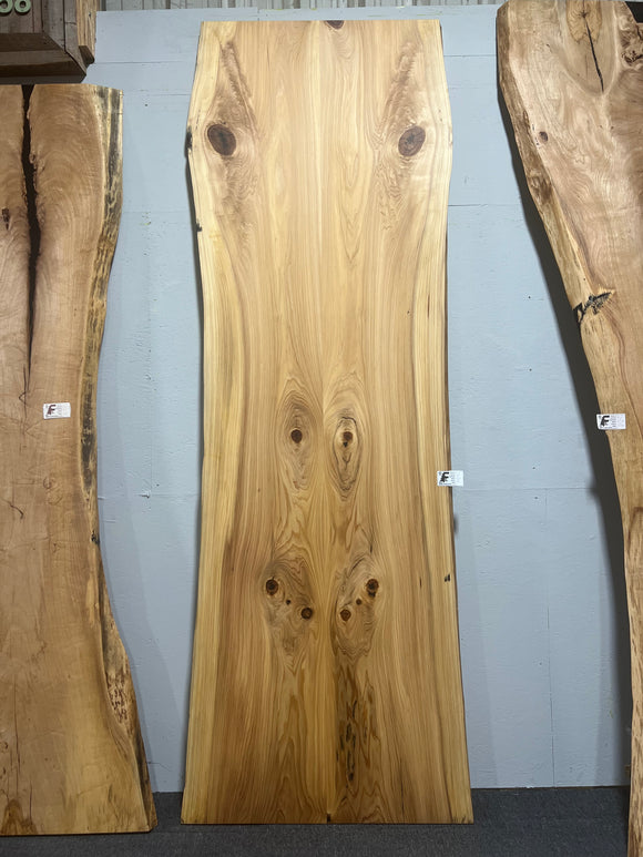 Natural cypress wood slab with rich grain patterns and live edge, perfect for custom dining tables or countertops