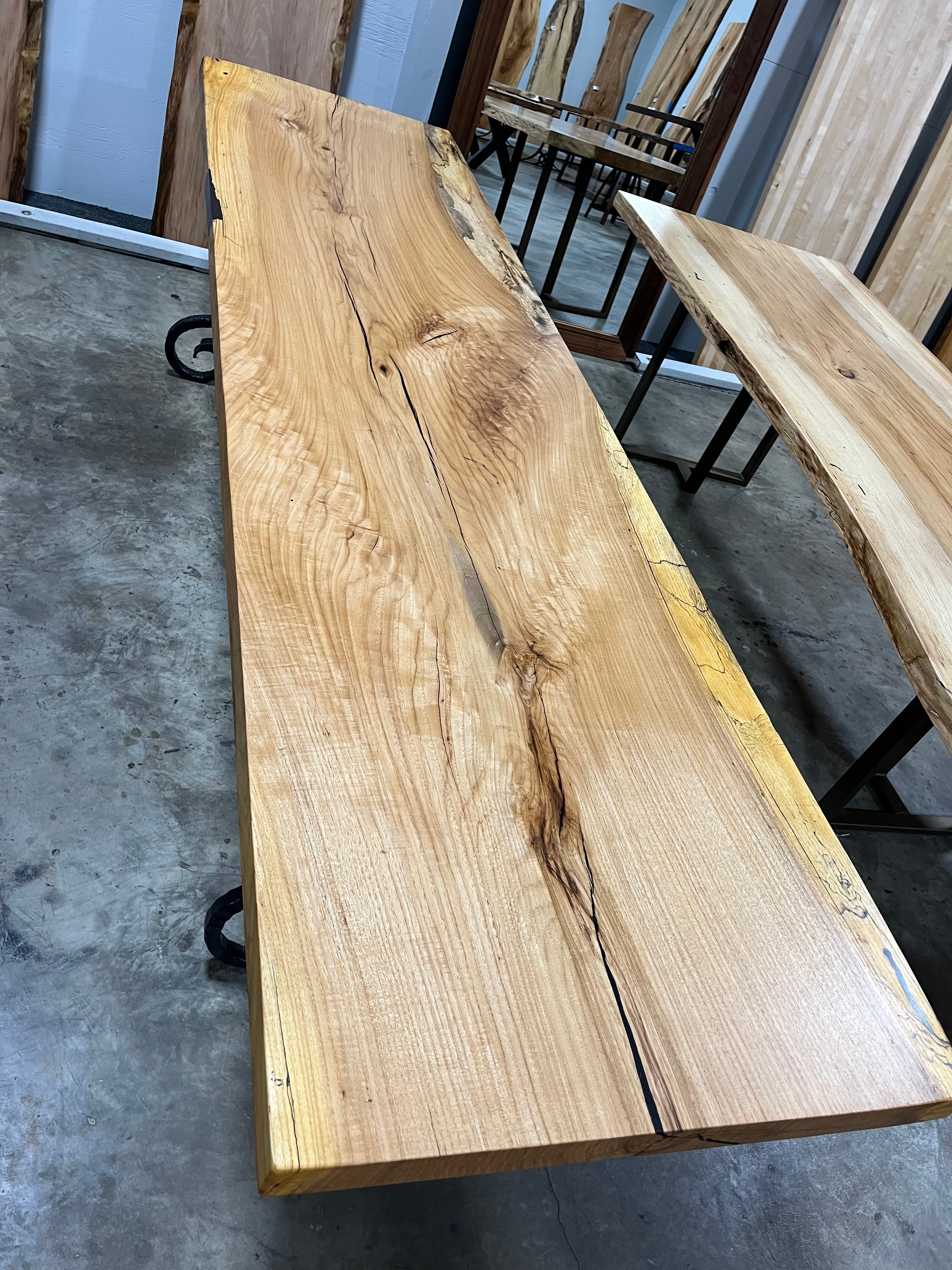 Live edge pecan slab with rich golden-brown tones, natural grain patterns, and organic edges