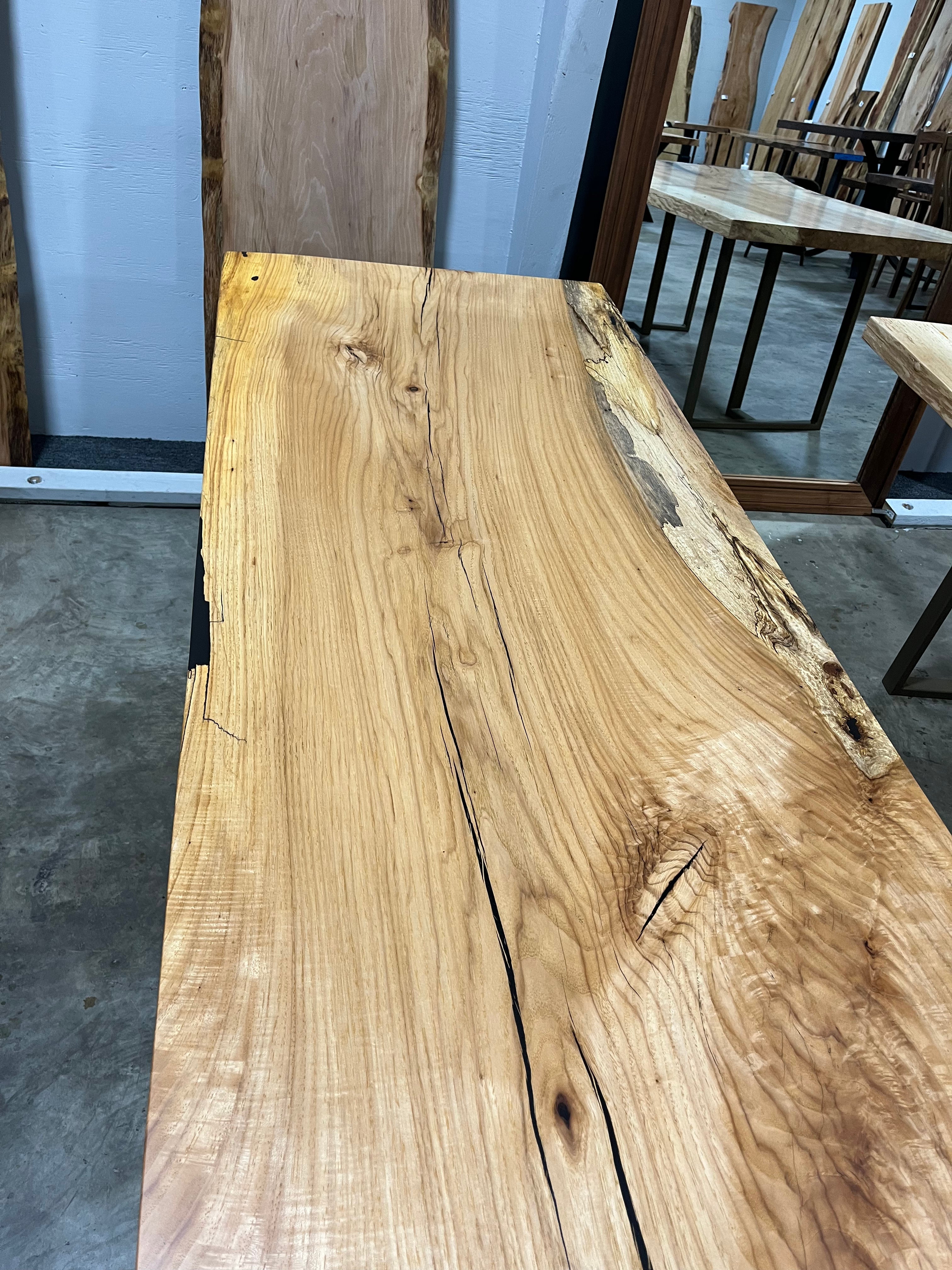 Live edge pecan slab with rich golden-brown tones, natural grain patterns, and organic edges