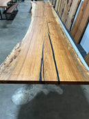 Live edge pecan slab with rich golden-brown tones, natural grain patterns, and organic edges