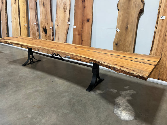 Live edge pecan slab with rich golden-brown tones, natural grain patterns, and organic edges