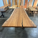 Live edge pecan slab with rich golden-brown tones, natural grain patterns, and organic edges