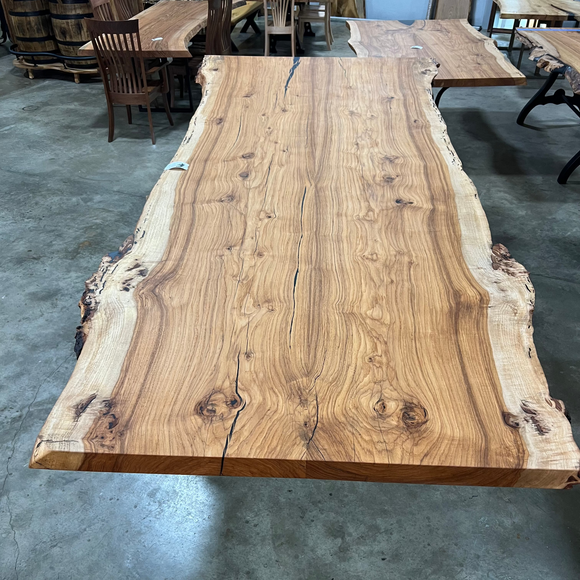 Live edge pecan slab with rich golden-brown tones, natural grain patterns, and organic edges