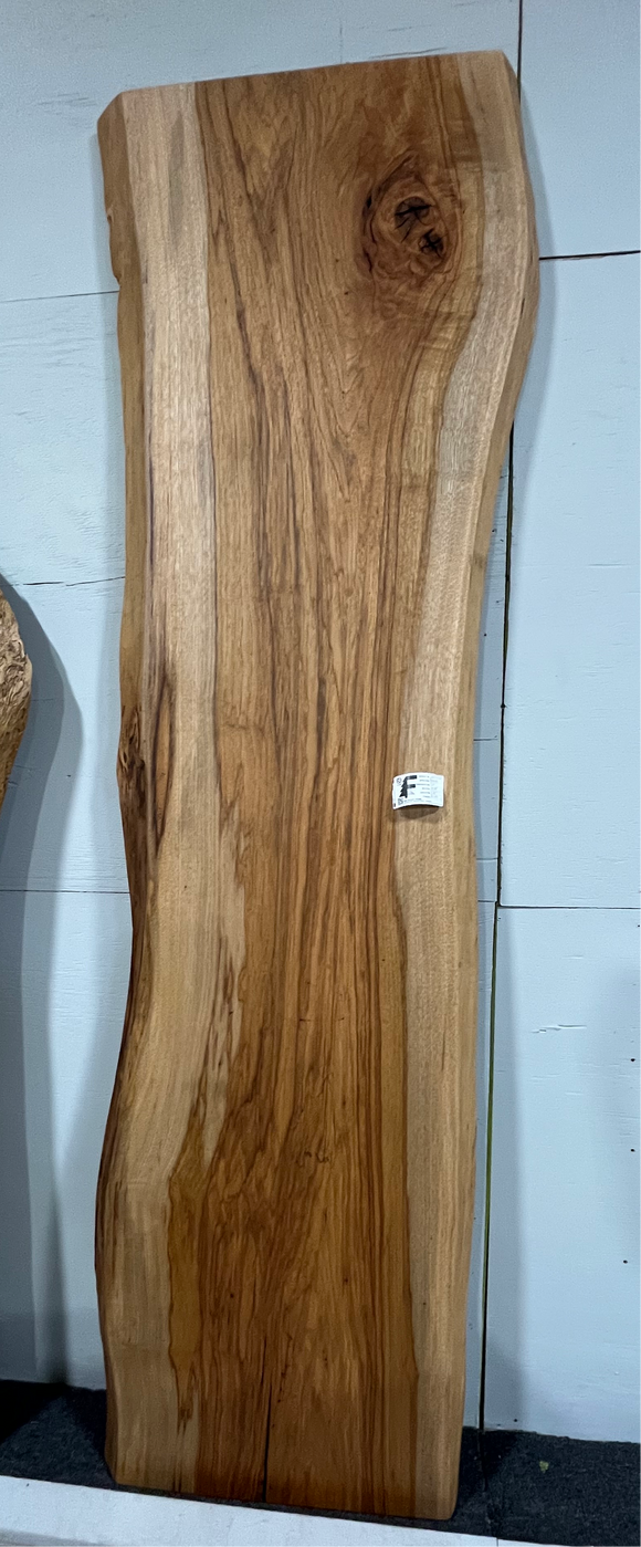 Live edge pecan slab with rich golden-brown tones, natural grain patterns, and organic edges