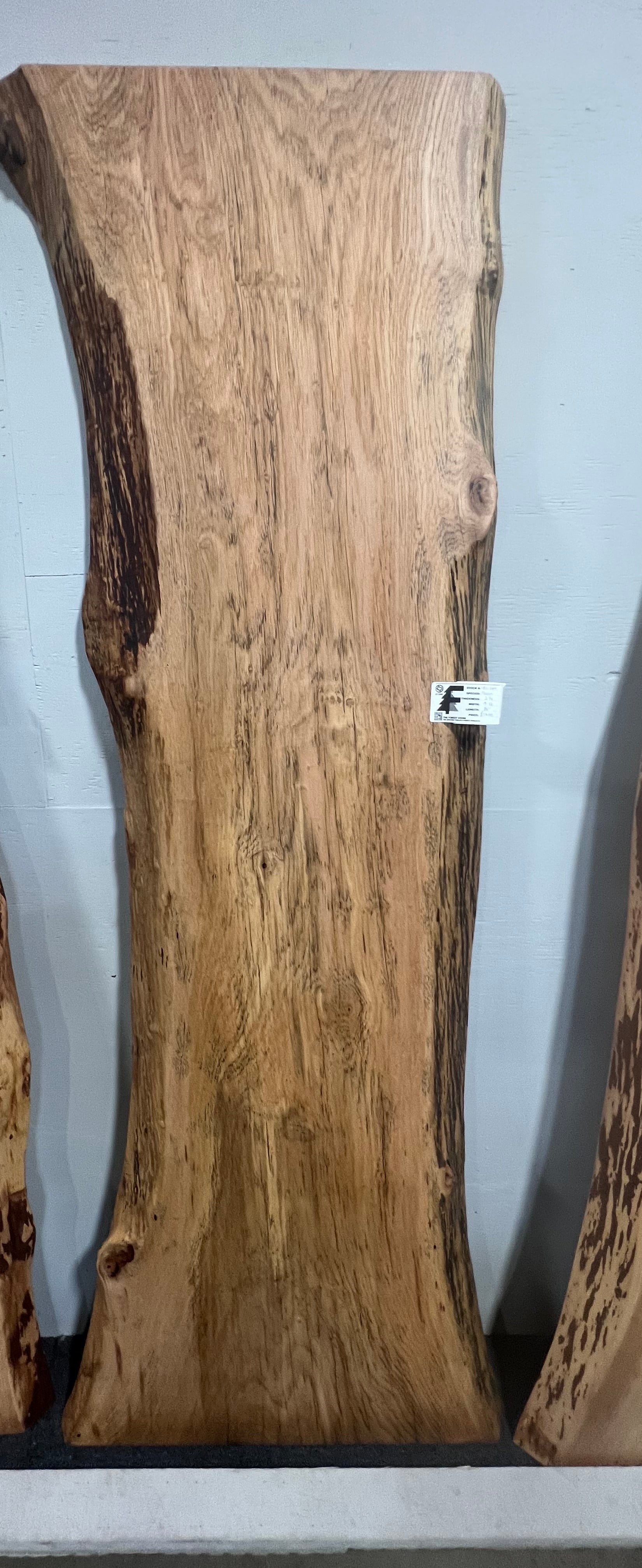 Live edge pecan slab with rich golden-brown tones, natural grain patterns, and organic edges