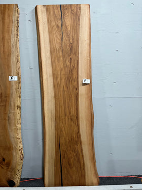 Live edge pecan slab with rich golden-brown tones, natural grain patterns, and organic edges
