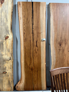 Live edge pecan slab with rich golden-brown tones, natural grain patterns, and organic edges
