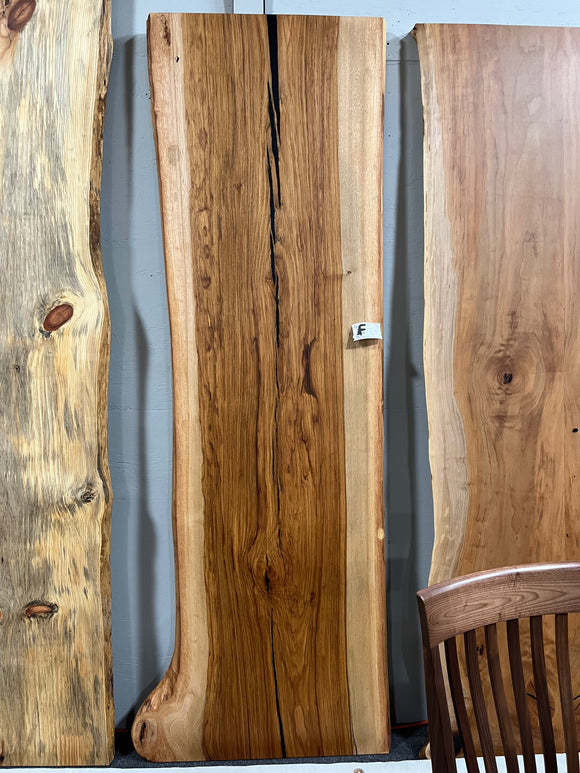 Live edge pecan slab with rich golden-brown tones, natural grain patterns, and organic edges
