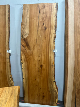 Live edge pecan slab with rich golden-brown tones, natural grain patterns, and organic edges
