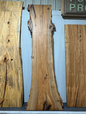 Live edge pecan slab with rich golden-brown tones, natural grain patterns, and organic edges
