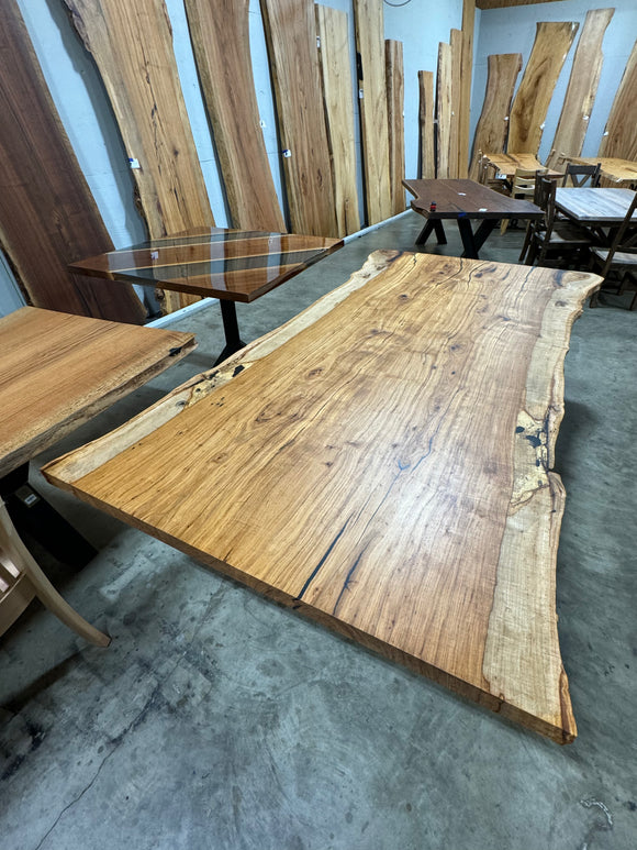 Live edge pecan slab with rich golden-brown tones, natural grain patterns, and organic edges
