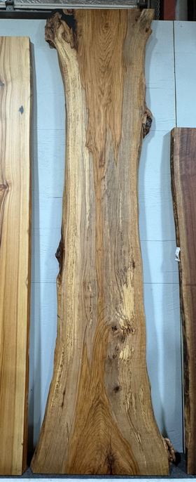 Live edge pecan slab with rich golden-brown tones, natural grain patterns, and organic edges
