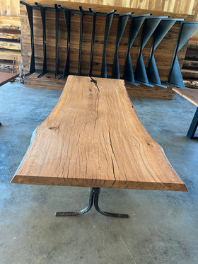 Close-up of a live edge post oak slab with natural grain and knots