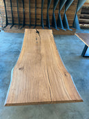 Close-up of a live edge post oak slab with natural grain and knots