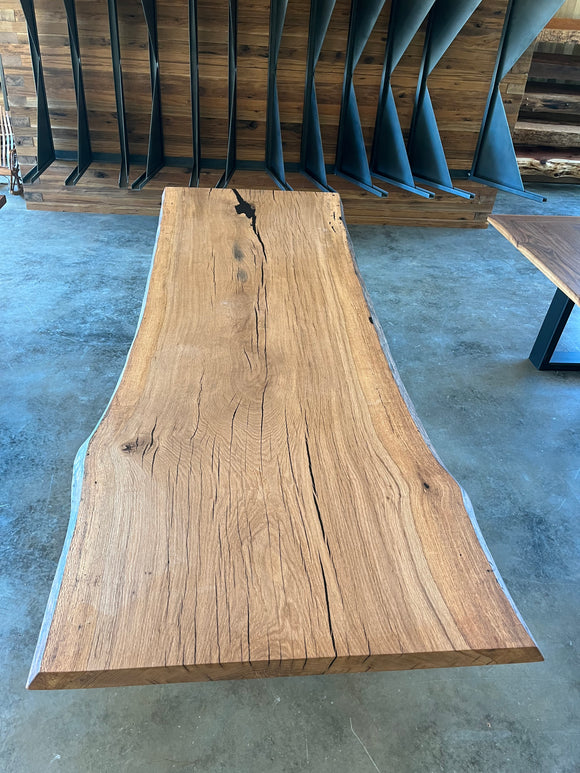 Close-up of a live edge post oak slab with natural grain and knots