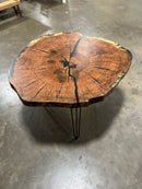 Live edge red oak wood slab with rich grain patterns, natural knots, and kiln-dried hardwood surface for custom furniture or table making.