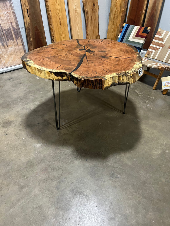 Live edge red oak wood slab with rich grain patterns, natural knots, and kiln-dried hardwood surface for custom furniture or table making.