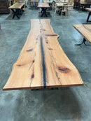 Live edge red oak wood slab with rich grain patterns, natural knots, and kiln-dried hardwood surface for custom furniture or table making.