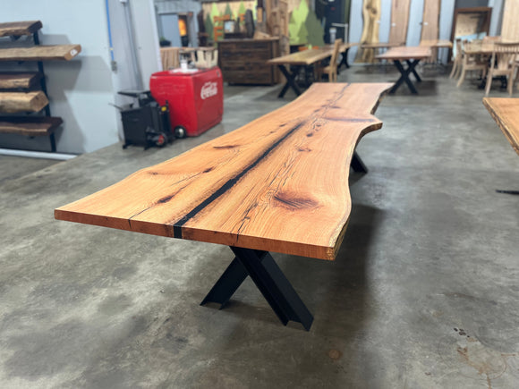 Live edge red oak wood slab with rich grain patterns, natural knots, and kiln-dried hardwood surface for custom furniture or table making.