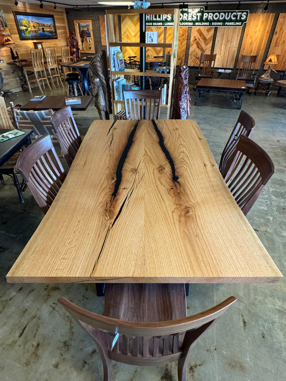 Live edge red oak wood slab with rich grain patterns, natural knots, and kiln-dried hardwood surface for custom furniture or table making.