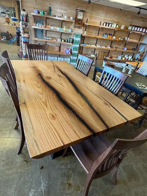 Live edge red oak wood slab with rich grain patterns, natural knots, and kiln-dried hardwood surface for custom furniture or table making.