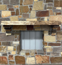 Solid live edge walnut fireplace mantel mounted on a stone wall.
