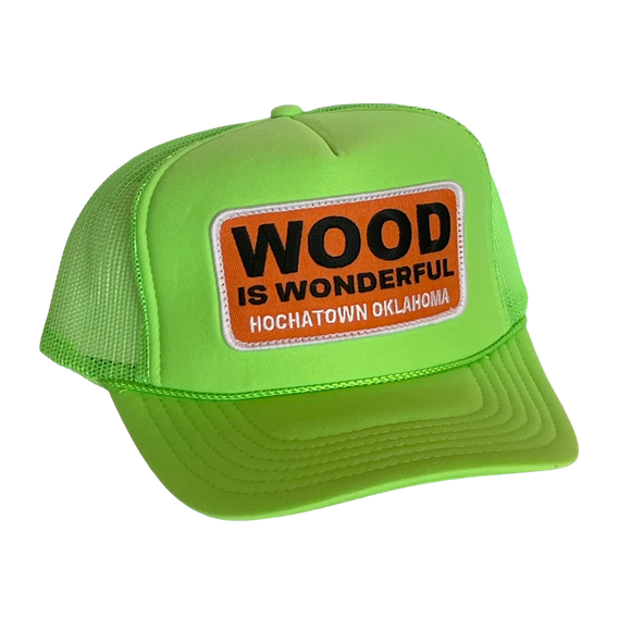 A neon green trucker hat with a Wood is Wonderful Hochatown Oklahoma patch