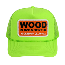 A neon green trucker hat with a Wood is Wonderful Hochatown Oklahoma patch