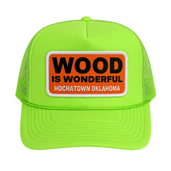 A neon green trucker hat with a Wood is Wonderful Hochatown Oklahoma patch