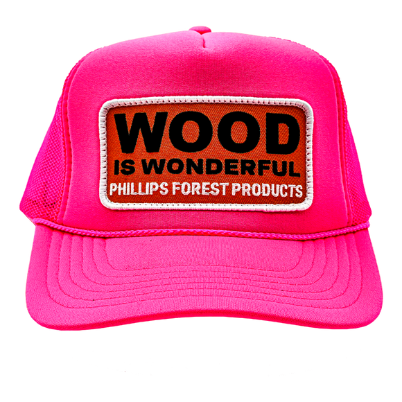 A neon pink trucker hat with a Wood is Wonderful Phillips Forest Products patch