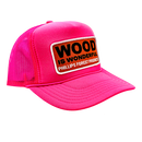 A neon pink trucker hat with a Wood is Wonderful Phillips Forest Products patch