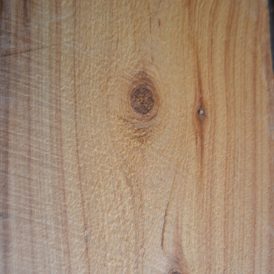 Close-up of a rough sawn cypress lumber with visible grain and knots
