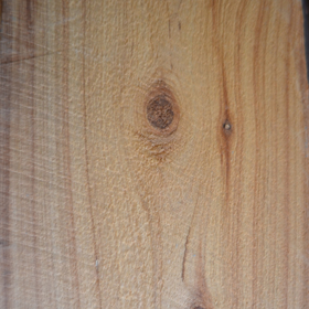 Close-up of a rough sawn cypress lumber with visible grain and knots