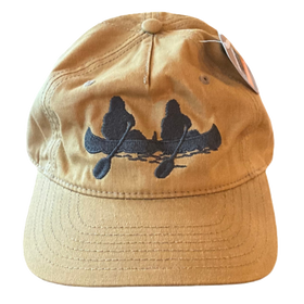 A khaki hat with a sasquatch in a canoe design