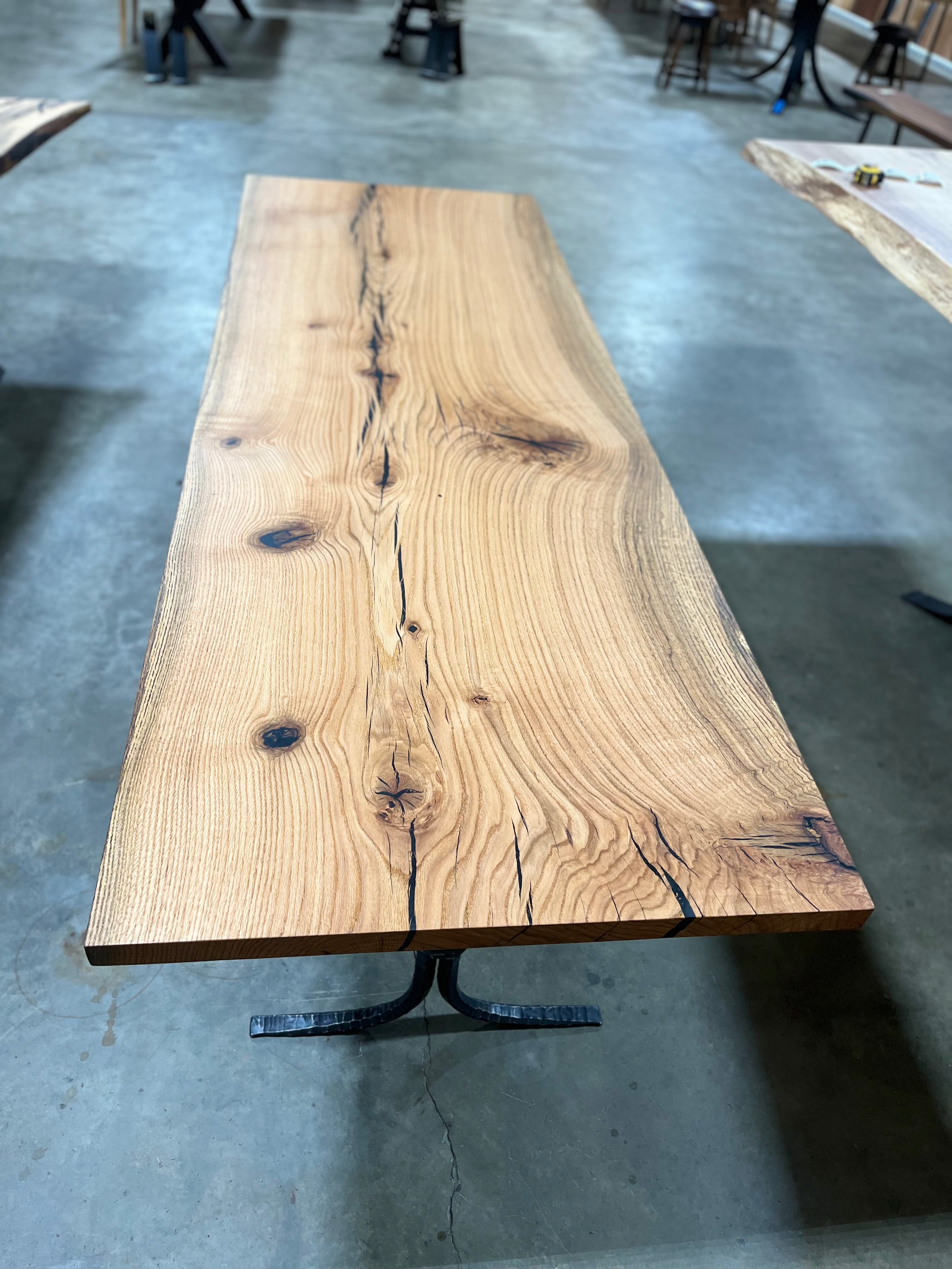 Square edge red oak wood slab with rich grain patterns, natural knots, and kiln-dried hardwood surface for custom furniture or table making.
