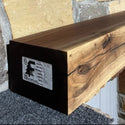 walnut beam fireplace mantel on a stone wall