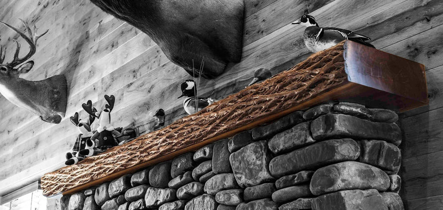 A cut of a tree with the bark on it used for a fireplace mantel. 