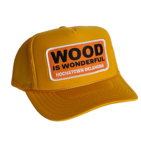 Yellow cap with 'Wood is Wonderful' patch on a white background