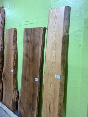 Finished live edge blue pine slab with natural grain and blue-gray streaks
