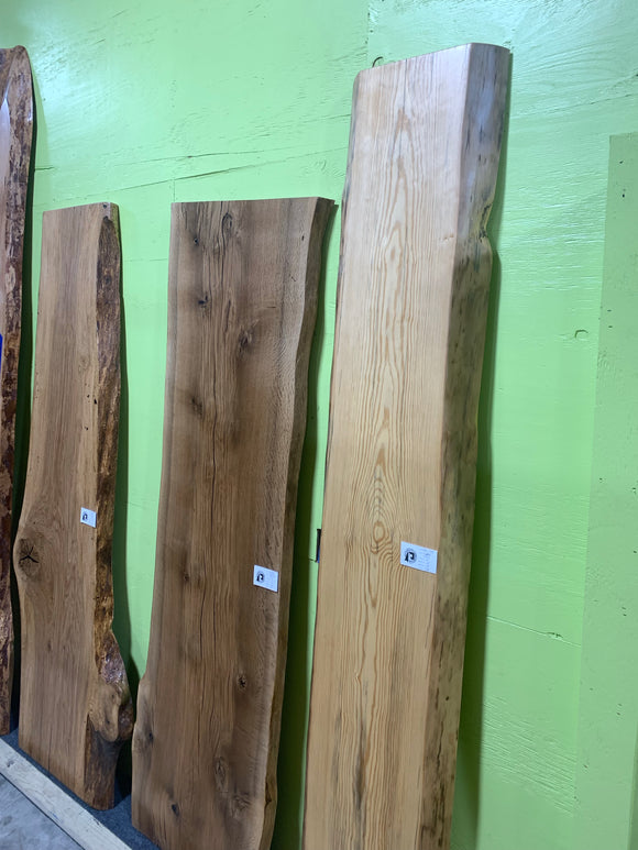 Finished live edge blue pine slab with natural grain and blue-gray streaks
