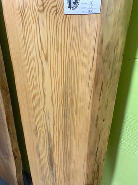 Finished live edge blue pine slab with natural grain and blue-gray streaks

