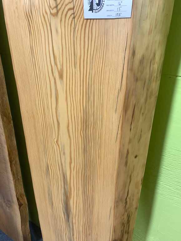 Finished live edge blue pine slab with natural grain and blue-gray streaks
