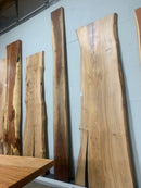 Live edge walnut wood slab with rich dark grain and natural edges.