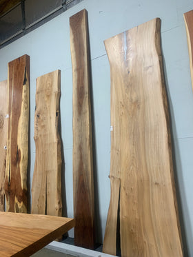 Live edge walnut wood slab with rich dark grain and natural edges.