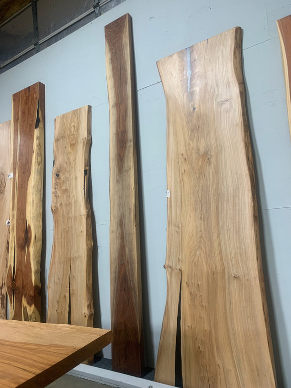 Live edge walnut wood slab with rich dark grain and natural edges.