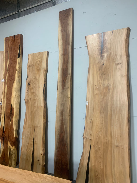 Live edge walnut wood slab with rich dark grain and natural edges.
