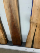 Live edge walnut wood slab with rich dark grain and natural edges.
